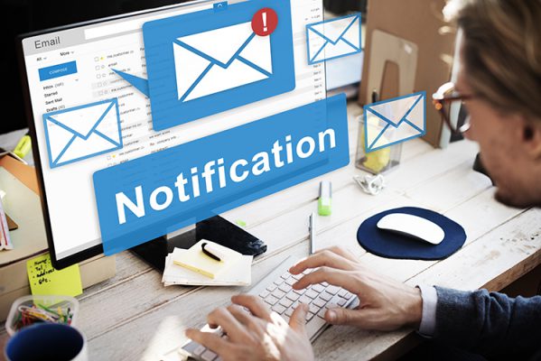 man reading computer screen with prominent notification displayed
