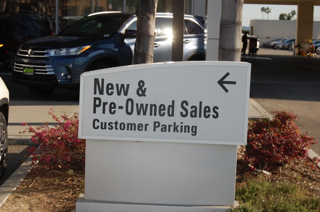 New & Pre-Owned Sales sign